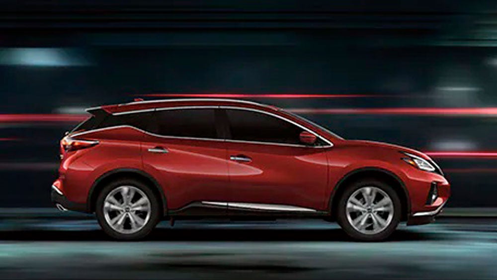 2023 Nissan Murano shown in profile driving down a street at night illustrating performance. | Auffenberg Nissan in Shiloh IL